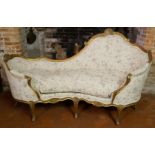 AN 18TH/19TH CENTURY FRENCH KIDNEY SHAPED TWO SEAT SETTEE With floral carved giltwood frame,