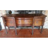 A GEORGIAN MAHOGANY SIDEBOARD The central section fitted with two drawers flanked by cupboards,