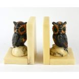 A PAIR OF ART DECO CARVED ALABASTER OWL FORM BOOKENDS Russett coloured owls set with glass eyes,