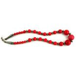 A CHINESE WHITE METAL AND RED CORAL NECKLACE With graduated spherical beads and white metal