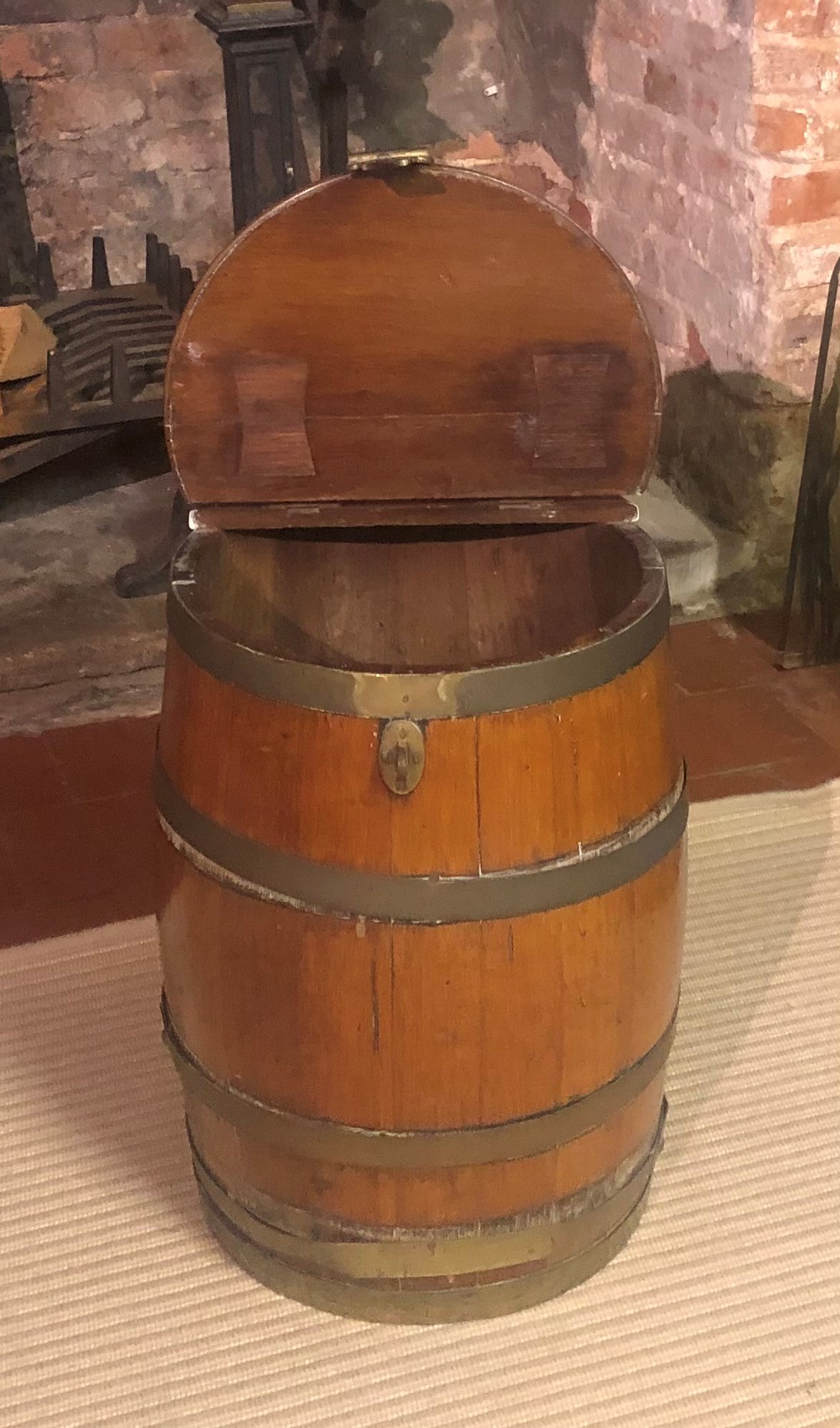 A VICTORIAN BRASS BOUND BARREL With rise and fall top and heavy brass fittings. (35cm x 49cm)