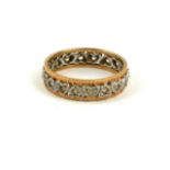 A VINTAGE 9CT BICOLOUR GOLD AND GEM SET WEDDING BAND The row of round cut stones in heart form mount