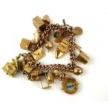 A VINTAGE 9CT GOLD CHARM BRACELET The Albert link bracelet with heart form lock set with 9ct gold