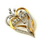 A VINTAGE 18CT WHITE AND YELLOW GOLD BROOCH ENCRUSTED WITH DIAMONDS FORMED AS ENTWINED HEARTS. (4.