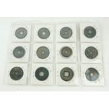 A COLLECTION OF TWELVE CHINESE BRONZE MEDALLIONS Each having a pierced square to centre, raised