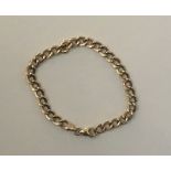 A 14CT GOLD FLAT CURB LINK BRACELET. (19cm)