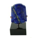 A LAPIS LAZULI CARVED BUDDHA PLAQUE Seated Buddha with inscription to top, on black perspex base. (