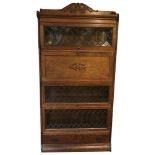 A GLOBE WERNICKE STYLE FIVE SECTION FLOORSTANDING SECRETARY BOOKCASE, CIRCA 1900 With leaded glass