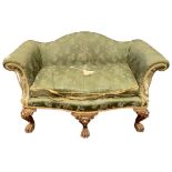 A 19TH CENTURY GEORGE II IRISH DESIGN SERPENTINE CARVED GILTWOOD SETTEE The humpback and scrolling