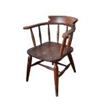 A 19TH CENTURY ELM SMOKER'S BOW ARMCHAIR The spindle back over a saddle seat, raised on turned