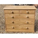 A VICTORIAN WAXED PINE CHEST OF TWO SHORT ABOVE THREE LONG DRAWERS.