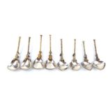STUART DEVLIN, A COLLECTION OF EIGHT SILVER GILT FIGURAL SPOONS In four pairs, Seahorses, dogs,