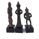 THREE ORIENTAL BRONZE MINIATURE FIGURES Standing poses, on perspex bases.