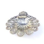 A SILVER SHELL FORM SWEETMEAT DISH Scalloped edge with engraved decoration and scrolled feet,