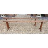 A PAIR OF 19TH CENTURY FRENCH CHERRY WOOD BENCHES. (220cm x 15.5cm x 54cm) Condition: some age