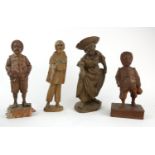 A COLLECTION OF 19TH CENTURY AND LATER CONTINENTAL WOODEN FIGURAL CARVINGS Three males in jovial