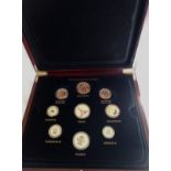 A GILT METAL AND ENAMEL 'CHANGING FACES OF BRITAIN'S COINAGE' SET Twenty-six coin set in three