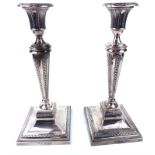 A PAIR OF VICTORIAN SILVER CANDLESTICKS Classical form with engraved decoration and square base,
