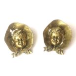 A PAIR OF VICTORIAN BRASS CHAMBER STICKS IN THE FORM OF A YOUNG GIRL WEARING BONNET Opening to