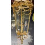 A LARGE POLISHED BRASS LANTERN The hexagonal tapering etched glazed panels above swags, shells and