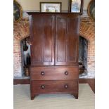 A VICTORIAN MAHOGANY LINEN PRESS The two panelled doors enclosing slides above two drawers, raised