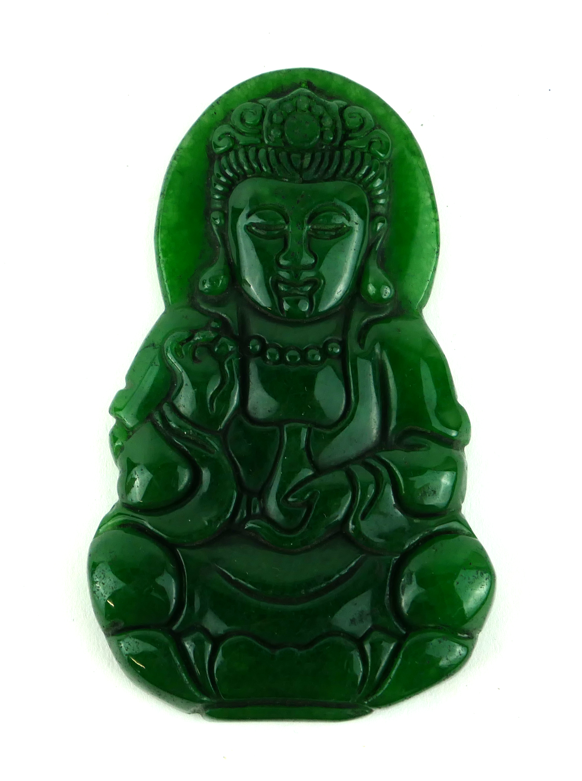 A CHINESE JADE CARVED BUDDHA PENDANT Seated pose, clutching a vessel. (approx 8cm) Condition: good