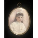 M. MELVIN, AN EARLY 20TH CENTURY OVAL MINIATURE PORTRAIT Young girl, signed, dated 1903, in a