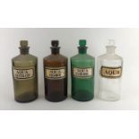 FOUR 19TH CENTURY COLOURED GLASS APOTHECARY BOTTLES AND STOPPERS. (18cm) Condition: good
