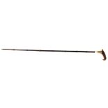 AN EDWARDIAN HORN HANDLED AND WHITE METAL BANDED LADIES' SWORD STICK In a faux bamboo scabbard. (