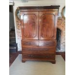 A GEORGIAN MAHOGANY AND CROSS BANDED HANGING CUPBOARD With dentil cornice above two doors