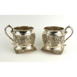 A PAIR OF VICTORIAN SILVER WINE CUP HOLDERS Having a single handle, raised decoration of classical