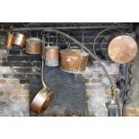 A HEAVY 19TH CENTURY COPPER AND IRON PAN Along with other copper kitchen utensils. (largest pan