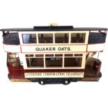 A VINTAGE WOODEN MODEL OF A ELECTRIC TRAM Titled 'Liverpool Corporation Tramways' on burgundy