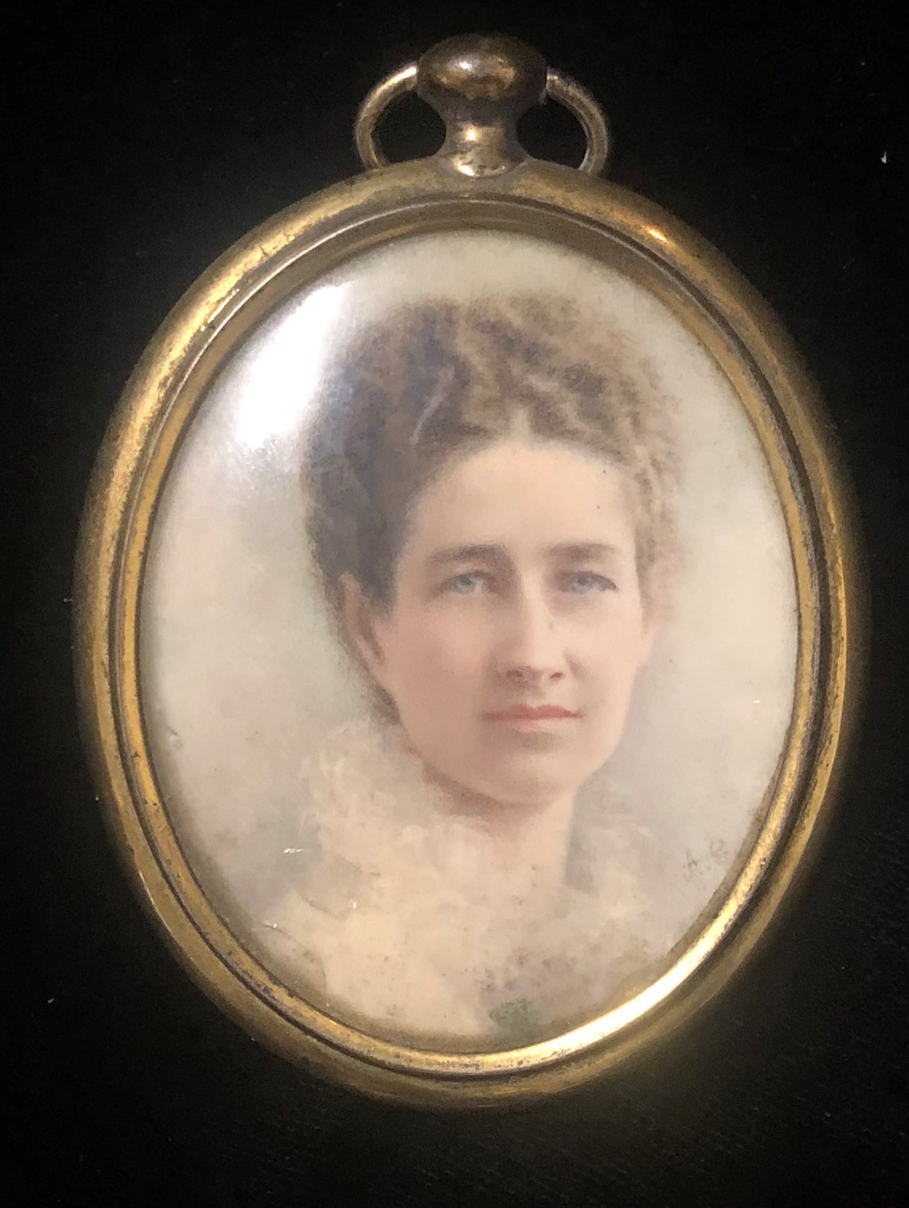 AN EDWARDIAN OVAL PORTRAIT MINIATURE Young lady, inscribed verso, signed with initials 'A.G.,