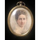 AN EDWARDIAN OVAL PORTRAIT MINIATURE Young lady, inscribed verso, signed with initials 'A.G.,