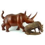 AN AFRICAN HARDWOOD CARVING OF A RHINOCEROS Along with a wild boar.