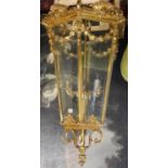 A LARGE POLISHED BRASS LANTERN The hexagonal tapering etched glazed panels above swags, shells and