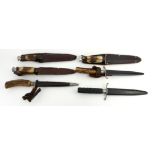A COLLECTION OF SIX EARLY 20TH CENTURY HORN HANDLED HUNTING DAGGERS Three having steel handles,
