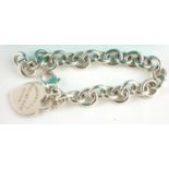 TIFFANY AND CO., A VINTAGE SILVER BRACELET The oval pierced links with heart form fob marked '
