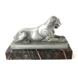 AN ART DECO ALUMINIUM AND MARBLE STATUE OF A LION Recumbent pose, on a rectangular marble plinth. (