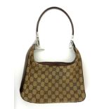 GUCCI, A VINTAGE LADIES' HANDBAG Brown leather strap, bearing 'GG' monogram and label to