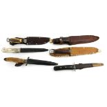 A COLLECTION OF SEVEN EARLY 20TH CENTURY HUNTING DAGGERS AND KNIVES Two with wooden handles, one