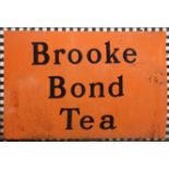 AN EARLY 20TH CENTURY ENAMEL 'BROOKE BOND TEA' RECTANGULAR ADVERTISING SIGN On an orange ground. (