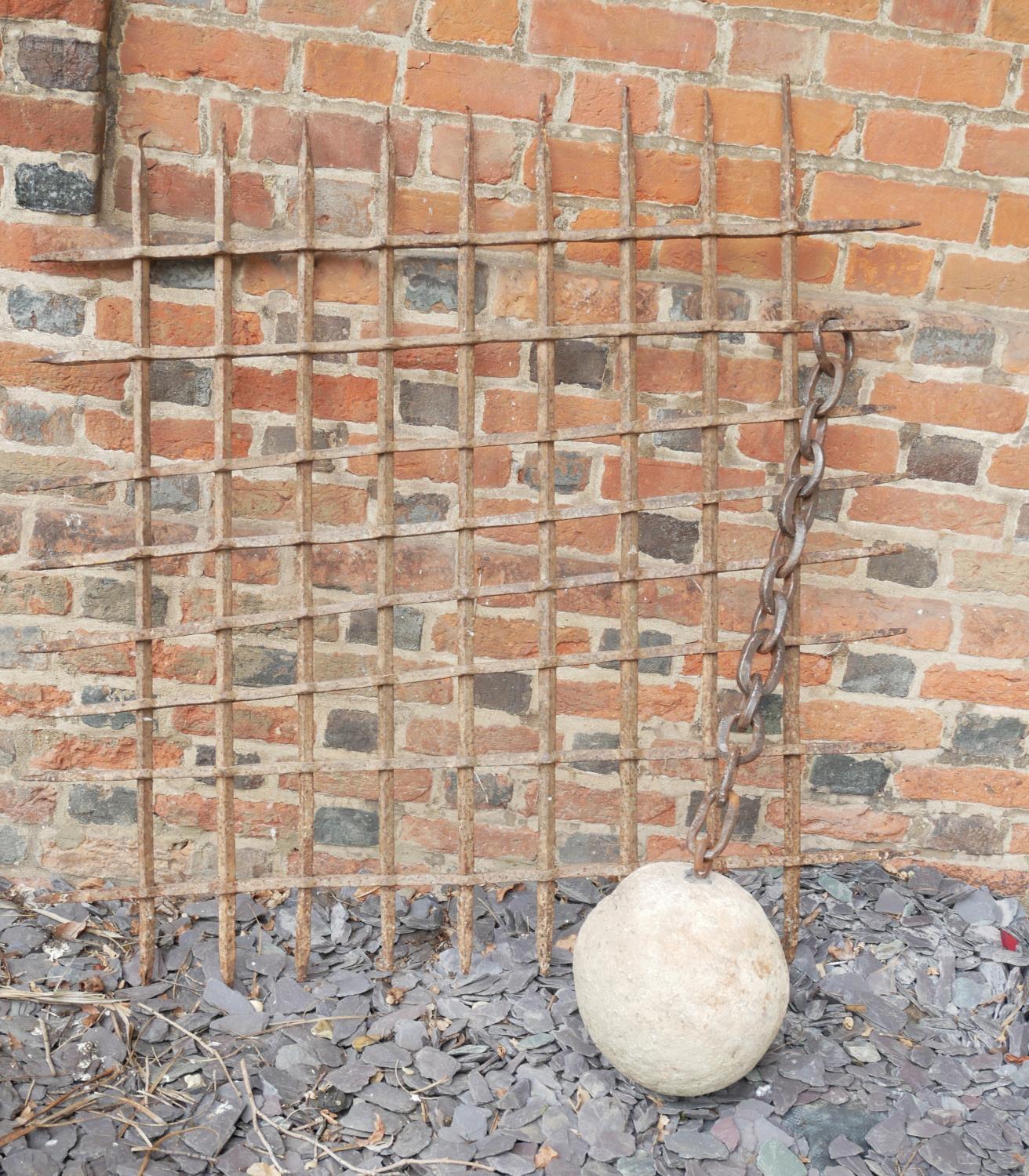 AN 18TH/19TH CENTURY WROUGHT IRON CONTINENTAL PRISON WINDOW Along with a stone ball and chain. (
