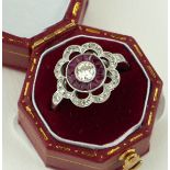 AN 18CT WHITE GOLD, RUBY AND DIAMOND FLOWER RING (size M½).