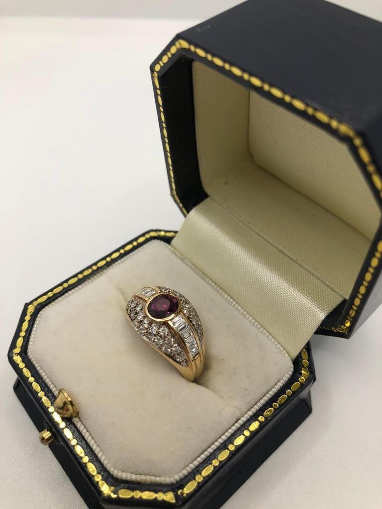 A 14CT GOLD, RUBY AND DIAMOND RING, CIRCA 1970 Pavé set with brilliant and baguette cut diamonds (