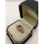 A 14CT GOLD, RUBY AND DIAMOND RING, CIRCA 1970 Pavé set with brilliant and baguette cut diamonds (