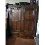 AN 17TH CENTURY OAK LIVERY CUPBOARD The two doors enclosing shelves and hanging rail. Condition: