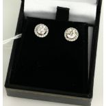 A PAIR OF DIAMOND 'HALO' STUD EARRINGS Each having a single round cut diamond edged with diamonds,