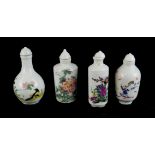 A COLLECTION OF FOUR CHINESE PORCELAIN SNUFF BOTTLES Hand painted with flowers and figures,